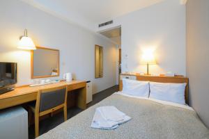 Postel nebo postele na pokoji v ubytování Shonandai Daiichi Hotel Fujisawa Yokohama