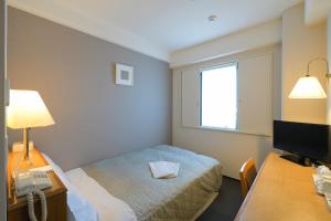 Postel nebo postele na pokoji v ubytování Shonandai Daiichi Hotel Fujisawa Yokohama