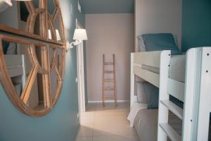 a bedroom with bunk beds and a mirror at Terradamare in Monopoli
