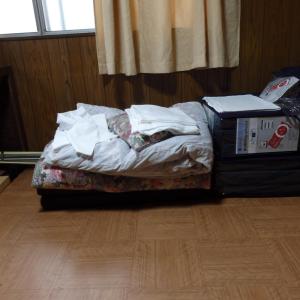 a unmade bed in a room with a wooden floor at Minshuku Mariko / Vacation STAY 895 in Mochimune