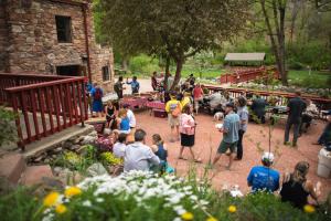 a group of people standing around in a garden at A-Lodge Boulder in Boulder