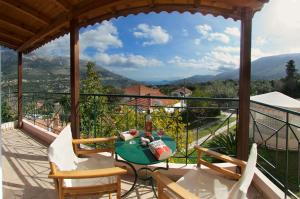 a patio with a table and chairs on a balcony at Dogis Retreat in Ayia Evfimia