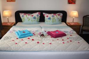 a bed with two pillows and flowers on it at Hotel Deutsches Haus in Cuxhaven