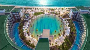 a large pool of water in front of a beach at Haven Riviera Cancun Adults Only in Cancún