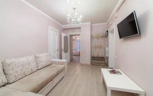 - un salon avec un canapé et une télévision dans l'établissement Apartments Deribasovskaya, à Odessa