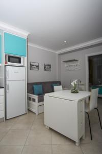 a kitchen and living room with a couch and a table at Ferhouse Dreams Pátria in Nazaré +31 photos