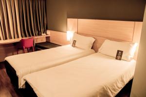 Cama ou camas em um quarto em ibis Sorocaba