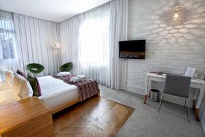 Televízia a/alebo spoločenská miestnosť v ubytovaní Platinum Residence Boutique