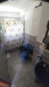 a bathroom with two blue toilets and a sink at Cabaña Negusa in Merlo +54 photos