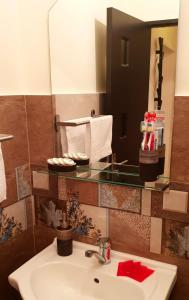 a bathroom with a sink and a mirror at Central Apartment DumDix Brasov in Braşov +3 photos