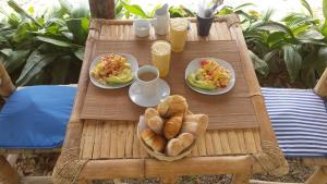a table with plates of food and bread on it at Villa al Fe in Los Órganos