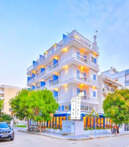 a large white building with trees in front of it at Dias Hotel in Alexandroupoli