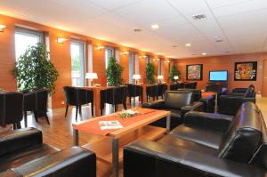 a waiting room with leather chairs and tables and tablesktop at Hotel SOREA REGIA in Bratislava +37 photos