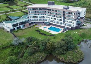 
a large building with a pool of water in front of it at Hotel Lagoon in Rionegro
