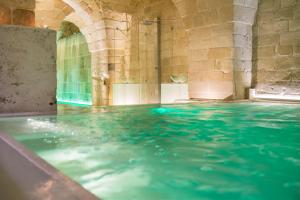 a swimming pool with blue water in a building at ReLuxe Private Wellness in Lecce