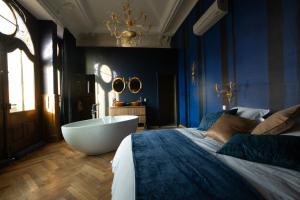 a bath room with a tub and a mirror at 1834 & Spa in Colmar