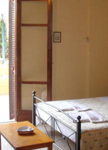 A bed or beds in a room at Alexandros Studios & Apartments