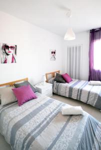 two beds in a bedroom with purple and white at Modern Apartment in Valencia in Valencia
