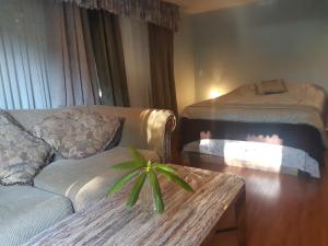 a living room with a couch and a table at Burris Guest House in Burnaby