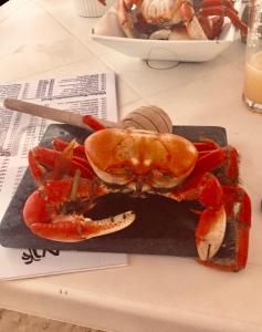 a crab on a plate on a table at Casas Aracaju Temporada in Aracaju