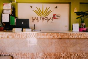 a hotel counter with a laptop on top of it at Las Tholas Hotel in Uyuni