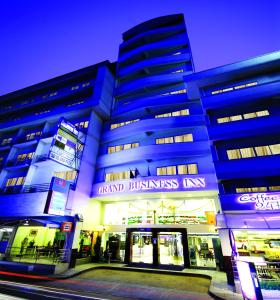 a large building with a sign that reads grand business inn at Grand Business Inn in Bangkok