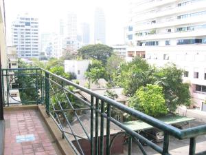 a balcony with a view of a city with buildings at Young Place in Bangkok