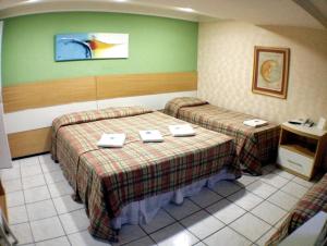 Katil atau katil-katil dalam bilik di Raio de Sol Praia Hotel