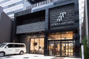 a white van parked in front of a building at Kuretake Inn Osaka Midousuji Hommachi in Osaka