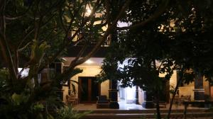 a building with a door in the middle of trees at Ayye Bungalows in Ubud