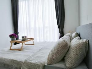 a bedroom with a bed with pillows and a table at Setapak Central, KL in Kuala Lumpur