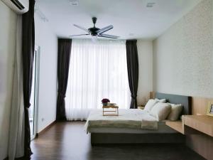 a bedroom with a bed and a ceiling fan at Setapak Central, KL in Kuala Lumpur