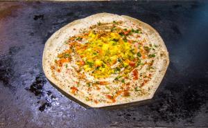 a pizza sitting on top of a table at Hotel Rockdale in Visakhapatnam