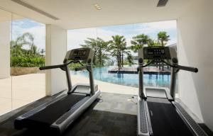 a gym with a view of a swimming pool at The heights Kata seaview large condo C1 in Kata Beach