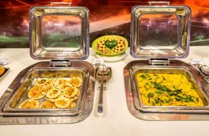 two trays of food on a table with food at Hotel Rockdale in Visakhapatnam