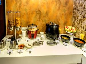 a table with pots and pans on top at Hotel Rockdale in Visakhapatnam
