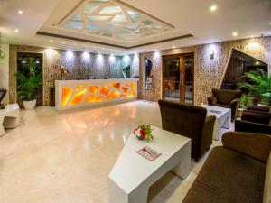 a lobby with a white table and chairs at Hotel Rockdale in Visakhapatnam