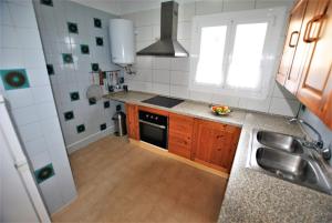 a small kitchen with a sink and a stove at Casa Serrans in Cala Mesquida