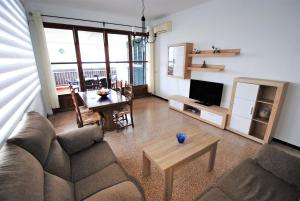 a living room with a couch and a table at Casa Serrans in Cala Mesquida