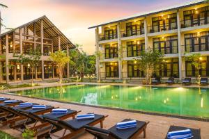 an image of a hotel with a swimming pool and chairs at Oak Ray Wild Yala in Tissamaharama
