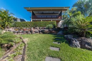 a house with a walkway leading to the front yard at Hayman Views in Airlie Beach