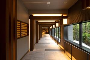 a hallway of a building with windows at Hotel Keihan Kyoto Hachijoguchi in Kyoto