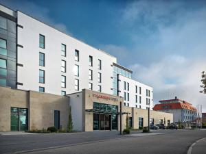 a large white building on the side of a street at Panoramahotel Waldenburg in Waldenburg