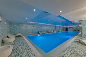 a swimming pool with blue walls and a blue floor at New Peterhof Hotel in Petergof