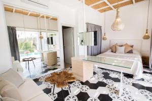 a bedroom with a bed and a glass table at Arkasa Palace in Arkasa