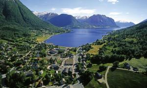 an aerial view of a small town next to a lake at Thon PartnerHotel Jølster in Skei