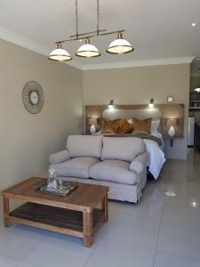 a living room with a couch and a bed at WILLOW MANOR in Clarens