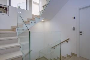 a glass staircase in a house at Hotel Vila Conte in Veli Lošinj