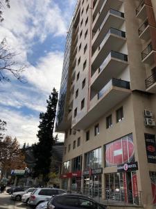 a tall building with cars parked in front of it at The K Tbilisi in Tbilisi City