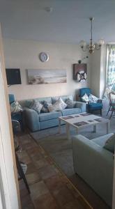 a living room with a blue couch and a table at The Sandgate in Skegness
